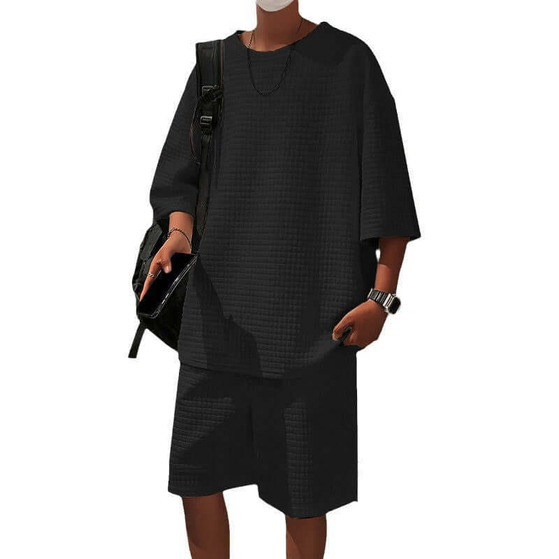 Men's loose short sleeve suit in black, featuring matching shorts and a casual top for relaxed style.